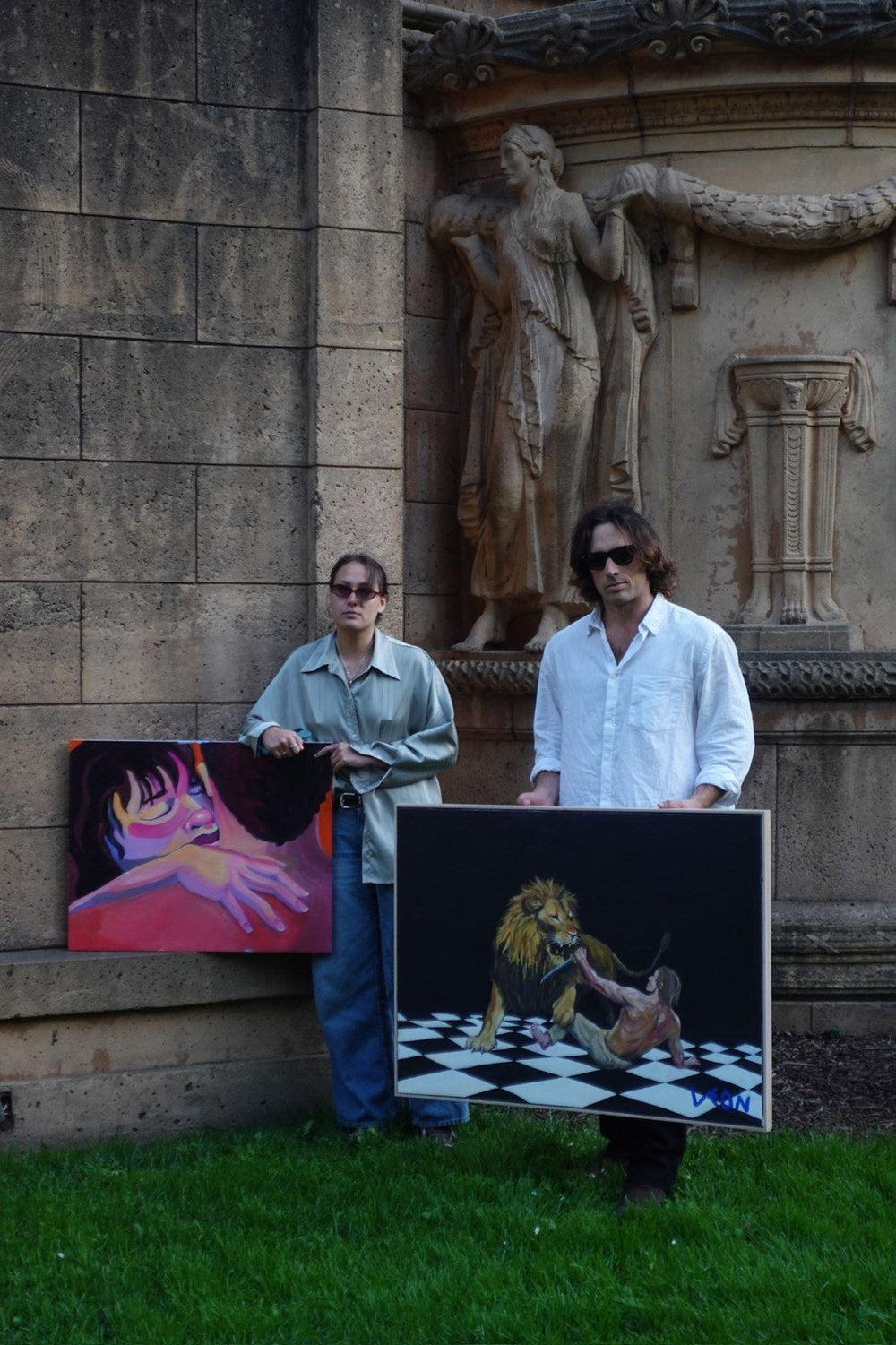 Camille Chiang and Leon Cummins with their paintings